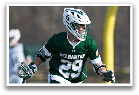 A man wearing a green and white uniform running on a field. Description generated by AI