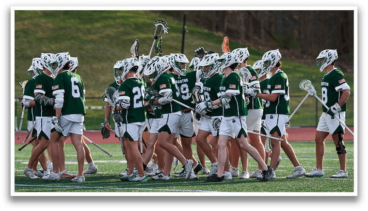 A group of people wearing green and white uniforms. Description generated by AI