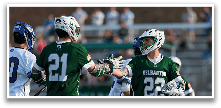 A group of men playing a game of lacrosse. Description generated by AI