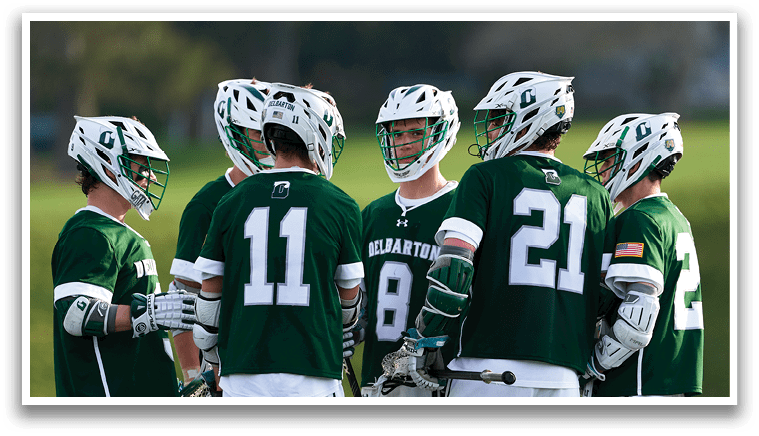 A group of men wearing green jerseys and helmets. Description generated by AI