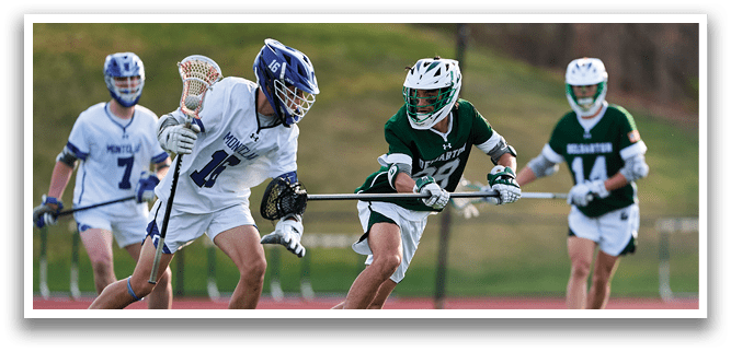 A man in a green and white uniform is running with a stick. Description generated by AI