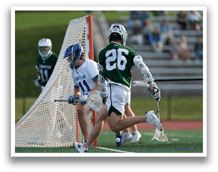 A man wearing a green shirt and white shorts is running with a lacrosse stick. Description generated by AI