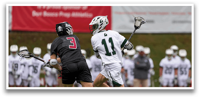 A man in a white shirt and green shorts is running with a lacrosse stick. Description generated by AI