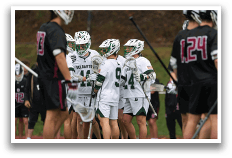 A group of people wearing white and green uniforms. Description generated by AI