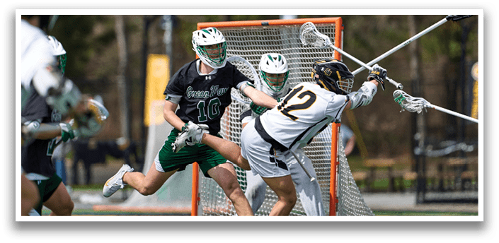 A man in a green jersey is running towards a goalie. Description generated by AI
