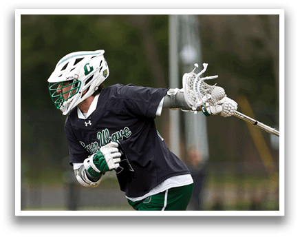 A man wearing a black shirt and green and white pants is playing lacrosse. Description generated by AI