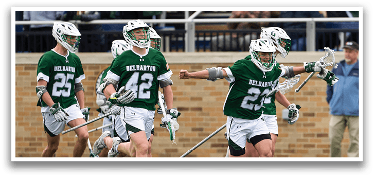A group of men playing lacrosse. Description generated by AI