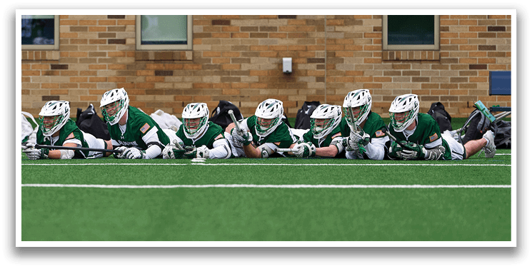 A group of hockey players sitting on the grass. Description generated by AI