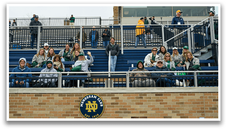 A group of people are sitting in the stands of a stadium. Description generated by AI