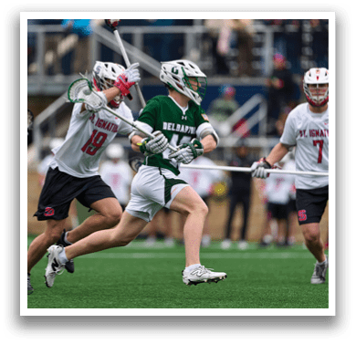 A group of men playing lacrosse. Description generated by AI