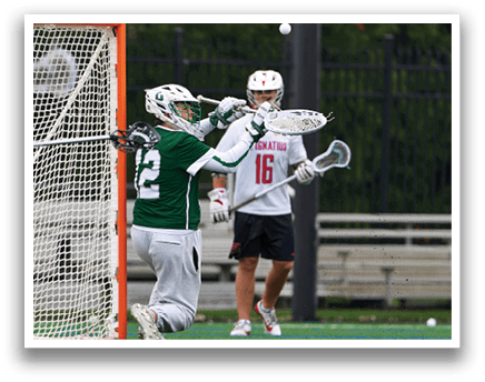A man wearing a green shirt and white shorts is playing lacrosse. Description generated by AI