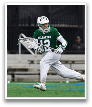 A man wearing a green and white uniform is running on a field. Description generated by AI