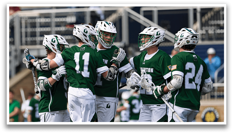 A group of men wearing green shirts and white shorts are hugging each other. Description generated by AI