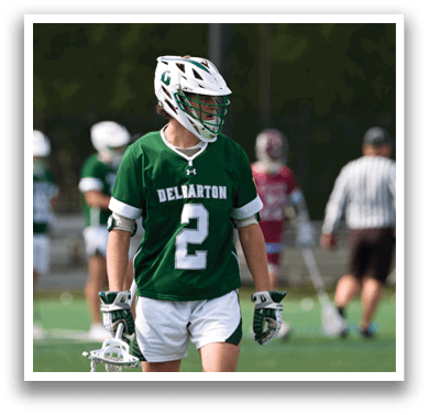 A man wearing a green jersey with the number 2 on it. Description generated by AI