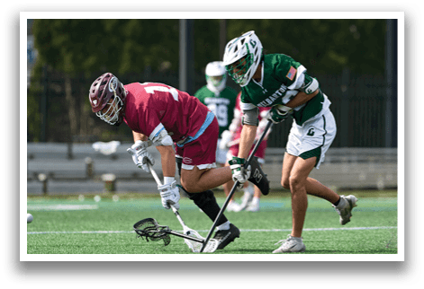 Two men playing a game of lacrosse. Description generated by AI