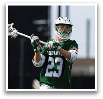 A man wearing a green jersey with the number 23 on it. Description generated by AI