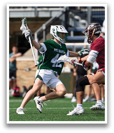 Two men playing lacrosse. Description generated by AI