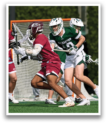 A group of men playing lacrosse. Description generated by AI