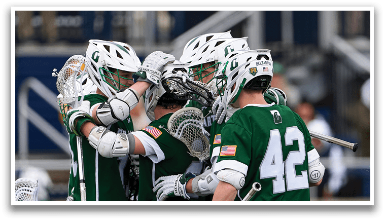 A group of men wearing green shirts and white shorts hugging each other. Description generated by AI