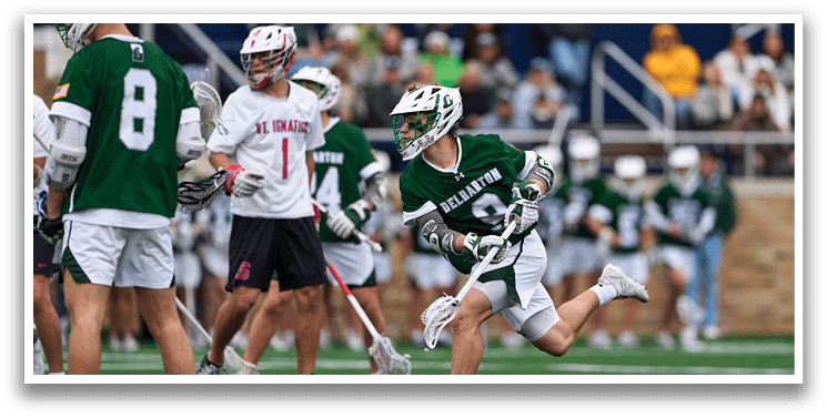 A group of men playing a game of lacrosse. Description generated by AI