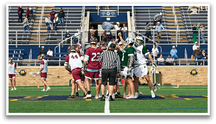A group of people playing a game of lacrosse. Description generated by AI