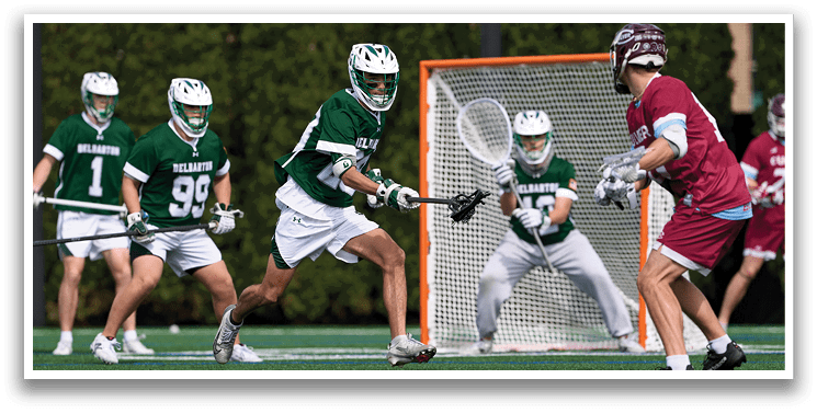 A group of people playing a game of lacrosse. Description generated by AI