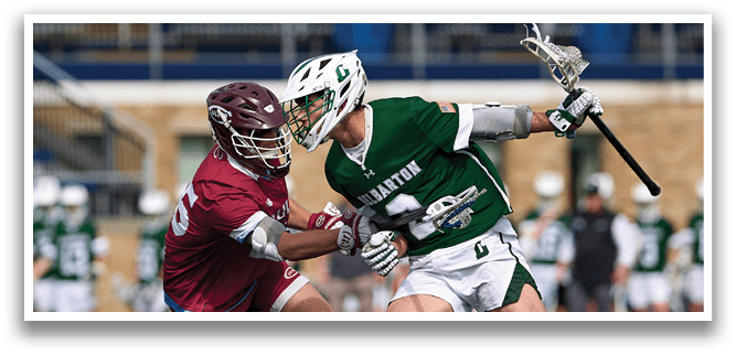 Two men playing a game of lacrosse. Description generated by AI