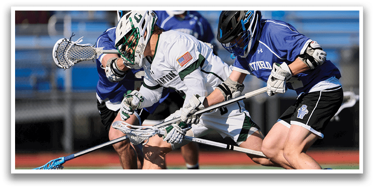 A group of men playing lacrosse on a field. Description generated by AI