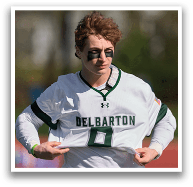 A man wearing a white jersey with the number 6 on it. Description generated by AI