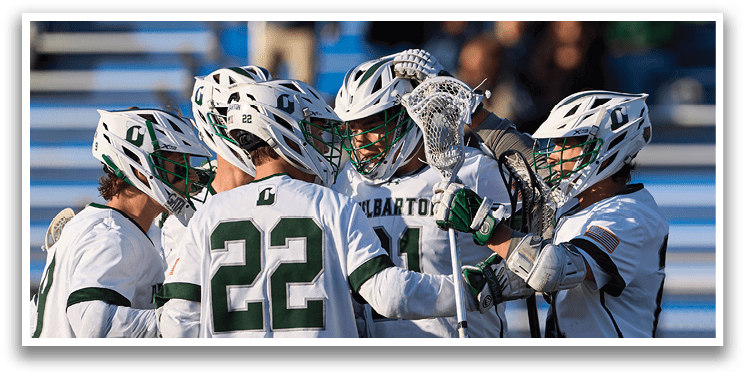 A group of lacrosse players huddled together. Description generated by AI