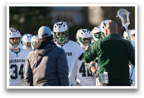 A group of people wearing white and green uniforms. Description generated by AI