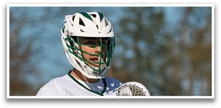 A man holding a lacrosse stick. Description generated by AI