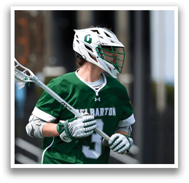 A man wearing a green and white jersey with the number 3 on it. Description generated by AI