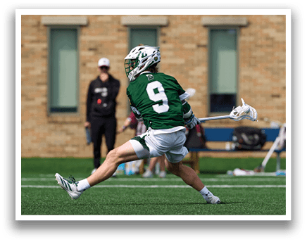 A man wearing a green and white uniform is running on a field. Description generated by AI