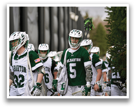 A group of people wearing green and white uniforms. Description generated by AI