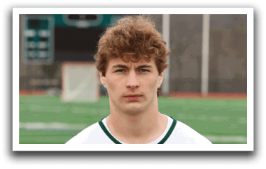 A man wearing a white and green Delaware jersey. Description generated by AI
