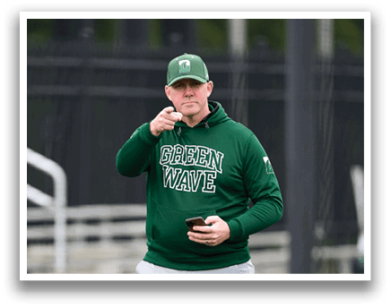 A man wearing a green hat and a green jacket. Description generated by AI