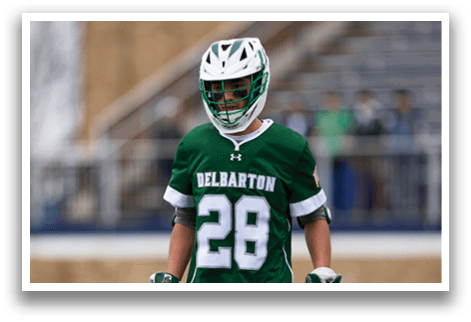 A man wearing a green and white jersey with the number 28 on it. Description generated by AI