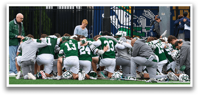 A group of people kneeling on a field. Description generated by AI