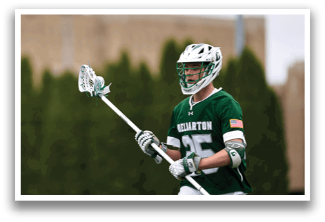 A man wearing a green and white jersey with the number 25 on it. Description generated by AI