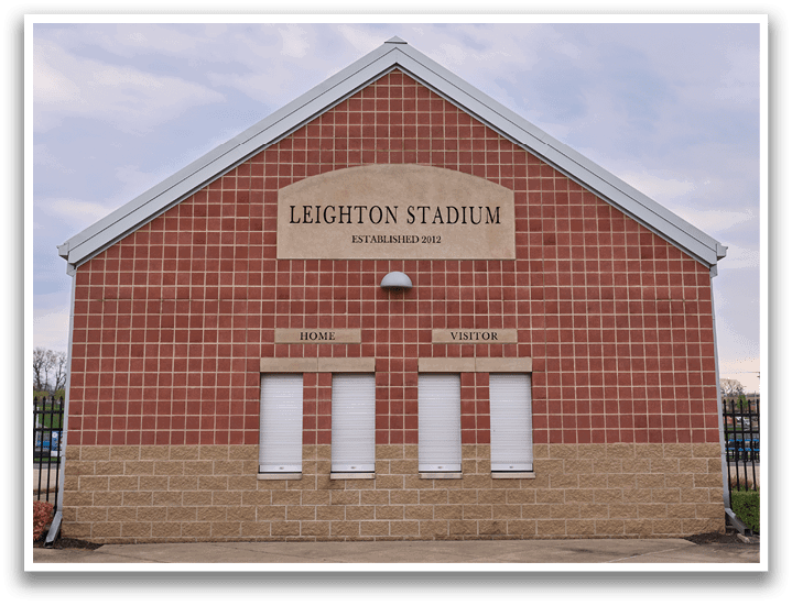 A brick building with a sign that says “Lighthon Stadium". Description generated by AI
