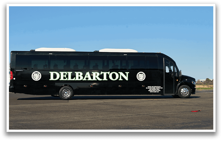 A Delbaron bus is parked on the side of the road. Description generated by AI