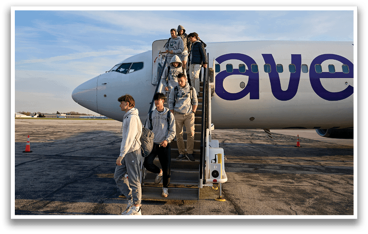 A group of people are boarding a plane. Description generated by AI