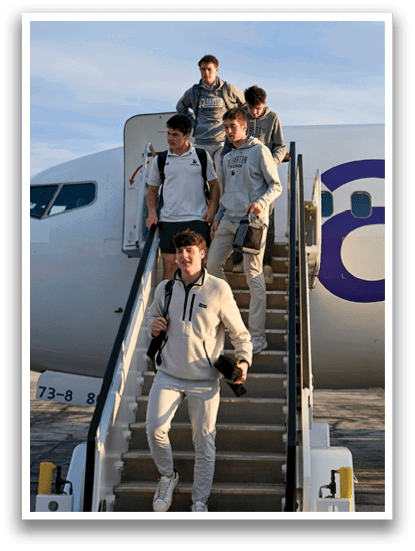 A group of people are walking up a staircase to a plane. Description generated by AI