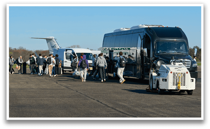 A group of people are walking towards a bus. Description generated by AI