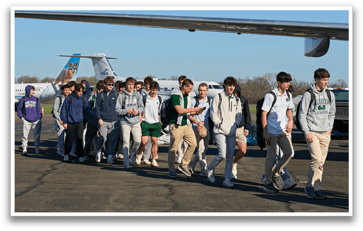 A group of people walking on a tarmac. Description generated by AI