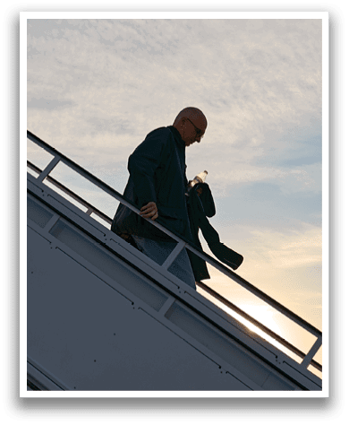 A man is walking down a stairway from an airplane. Description generated by AI