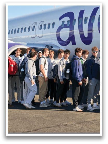 A group of people walking on the tarmac. Description generated by AI