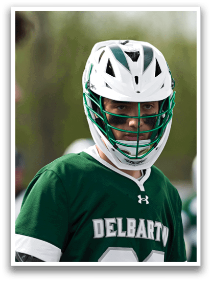 A man wearing a green and white jersey with the number 23 on it. Description generated by AI
