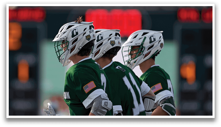 Three men wearing green and white uniforms. Description generated by AI